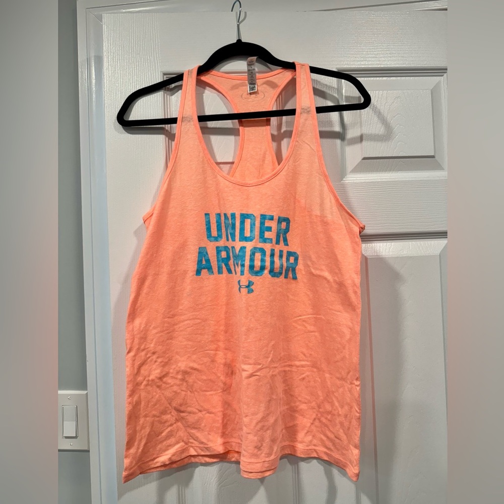 Women’s Under Armour Tank Top. Peach/orange color with Turquoise Blue writing.
